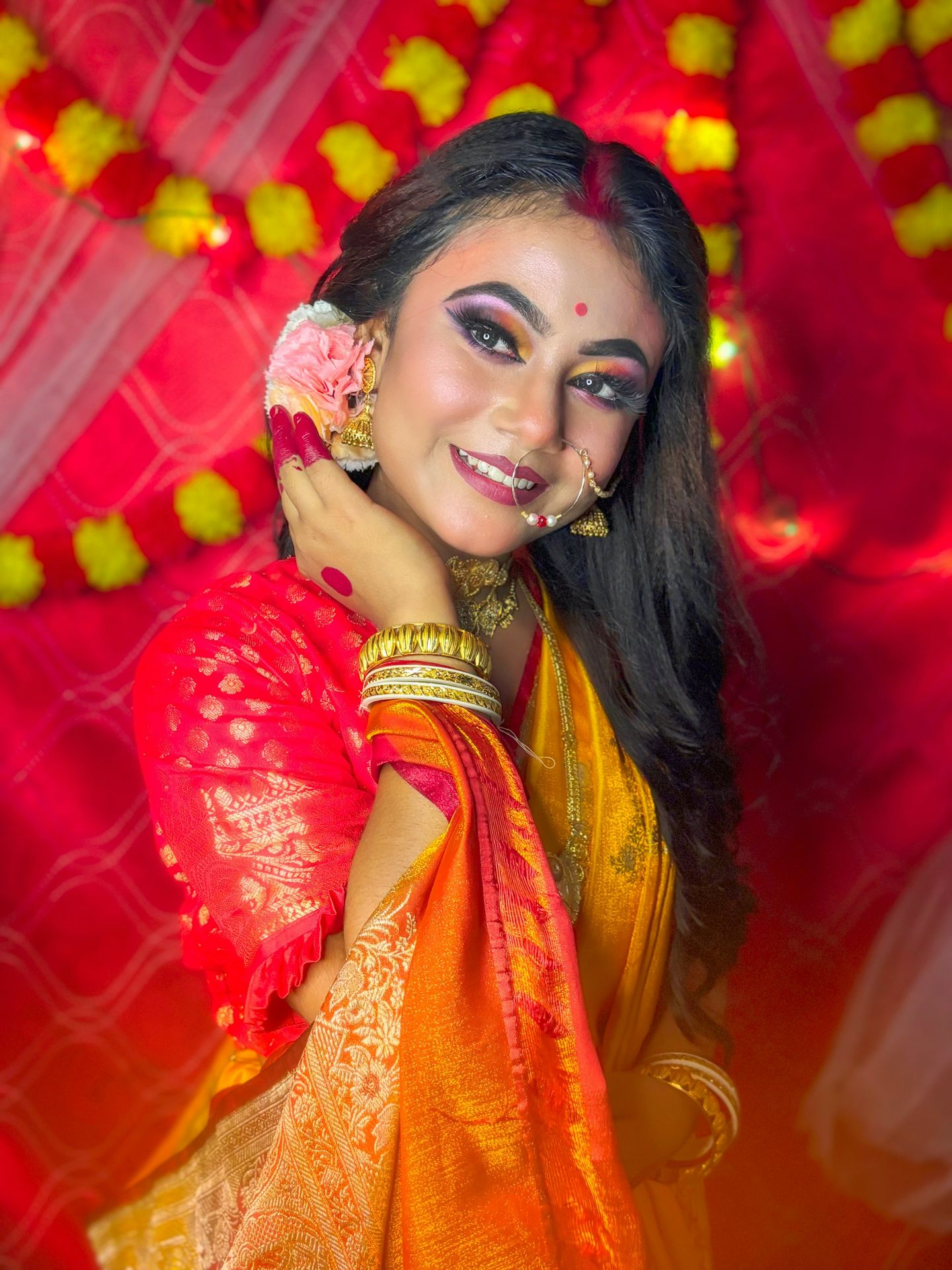 Beautiful woman in traditional bengali attire smiles.